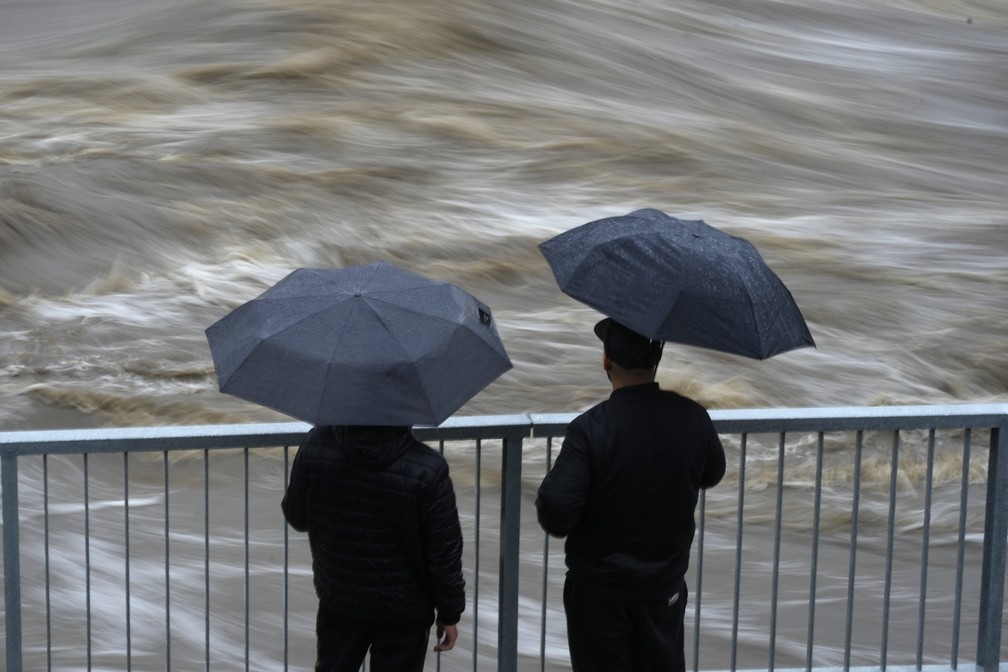 Moradores observam o fluxo do rio Bela durante as enchentes em Mikulovice, na República Tcheca, neste sábado, 14 de setembro de 2024. — Foto: AP Photo/Petr David Josek