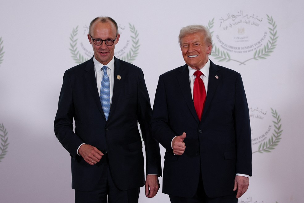 Presidente dos Estados Unidos, Donald Trump, cumprimenta o chanceler alemão, Friedrich Merz, na recepção da cúpula da paz em Gaza sediada em Sharm El-Sheik, no Egito, em 13 de outubro de 2025. — Foto: REUTERS/Suzanne Plunkett/Pool